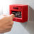 Person's fist punching a fire alarm